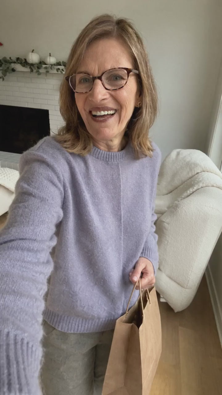 AI-generated presenter showing the black Everyday Tank with built-in bra as a gift idea